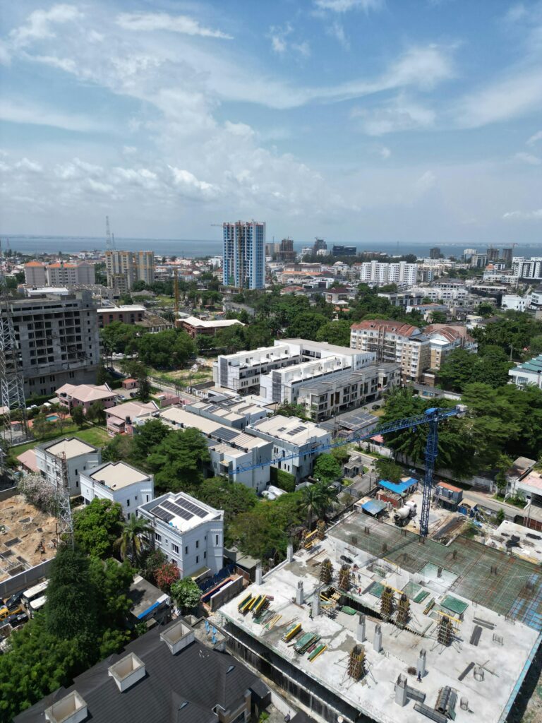 Aerial view of cityscape in Lagos with ongoing construction and clear sky.