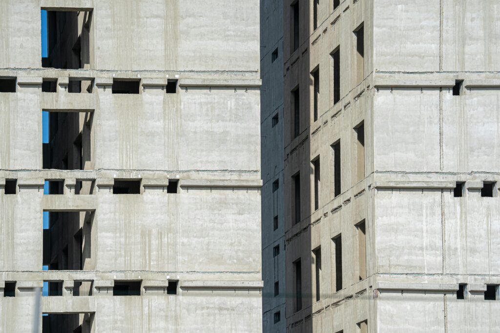 Close-up of an unfinished high-rise building with concrete structure.