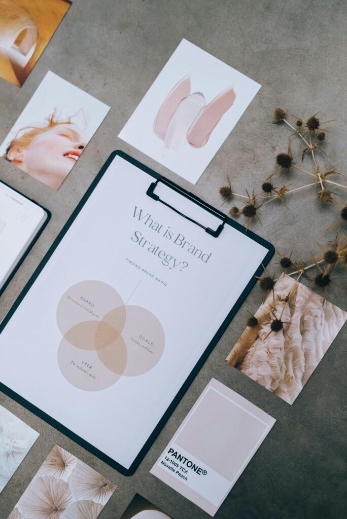 Overhead view of brand strategy documents with artistic visuals for business planning.